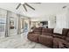 Comfortable living room showcasing wood-look floors and seamless transition to the kitchen and dining areas at 14637 Red Castle Ave, Lithia, FL 33547