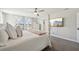Bright bedroom featuring a four-poster bed and large television on the wall at 14637 Red Castle Ave, Lithia, FL 33547