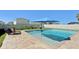 Backyard pool with lounge chairs, landscaped yard, and outdoor lighting at 14637 Red Castle Ave, Lithia, FL 33547
