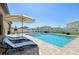 Backyard pool and patio with outdoor seating and landscaped surroundings at 14637 Red Castle Ave, Lithia, FL 33547