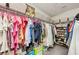 Walk-in closet with extensive hanging racks and shoe storage at 14637 Red Castle Ave, Lithia, FL 33547