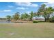 Expansive backyard featuring a serene pond and lush green space, perfect for outdoor activities at 1508 W Del Webb Blvd, Sun City Center, FL 33573