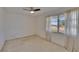 Bright bedroom features a ceiling fan and a large window for natural light at 1508 W Del Webb Blvd, Sun City Center, FL 33573