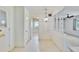 Bright hallway with speckled tile flooring and decorative lighting at 1508 W Del Webb Blvd, Sun City Center, FL 33573