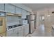 Efficient kitchen features white cabinets and modern stainless steel refrigerator at 1508 W Del Webb Blvd, Sun City Center, FL 33573