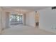 Spacious living room featuring neutral carpet, chandelier lighting, and large glass doors opening to a sunroom at 1508 W Del Webb Blvd, Sun City Center, FL 33573