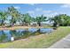 Scenic view of pond and surrounding greenery creating a tranquil and picturesque setting near the home at 1508 W Del Webb Blvd, Sun City Center, FL 33573