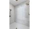 Modern shower featuring double shower heads, marble detail, and tiled floor at 16119 6Th E St, Redington Beach, FL 33708