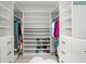 Spacious walk-in closet with custom shelving and hanging storage for clothes and shoes at 16119 6Th E St, Redington Beach, FL 33708