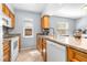 Functional kitchen featuring granite countertops, wood cabinetry, and modern white appliances at 16858 Le Clare Shores Dr, Tampa, FL 33624