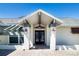 A close-up view of the beautiful double door entrance and covered porch of the home at 1924 E View Dr, Sun City Center, FL 33573