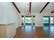 Living room with wood-look floors, exposed beams, and a bay window with water views at 1924 E View Dr, Sun City Center, FL 33573