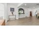 Bright foyer with stylish console table and arched doorway, leading to living and dining areas at 201 Flamingo Dr, Belleair, FL 33756