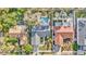 Drone's-eye view shows backyard pools, lush landscaping, and architectural details of beautiful homes at 230 Lotus Dr, Safety Harbor, FL 34695