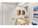 Bright bathroom featuring a vanity with a mirror, a sink, and well-lit space at 230 Lotus Dr, Safety Harbor, FL 34695