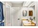 Bright bathroom features a skylight, marble countertop and a large mirror at 230 Lotus Dr, Safety Harbor, FL 34695
