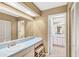 Spacious bathroom featuring a vanity, large mirror, natural light, and storage at 230 Lotus Dr, Safety Harbor, FL 34695