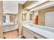 Bathroom with a dual vanity, a large mirror, a connecting bedroom, and good lighting at 230 Lotus Dr, Safety Harbor, FL 34695
