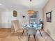 Dining room featuring modern table, chairs, chandelier, and view to the entryway at 230 Lotus Dr, Safety Harbor, FL 34695