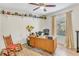 Cozy home office featuring desk with shelves and a comfortable rocking chair at 230 Lotus Dr, Safety Harbor, FL 34695