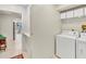Clean and functional laundry room features appliances and storage, connecting seamlessly to the home at 230 Lotus Dr, Safety Harbor, FL 34695