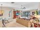 The inviting living room offers a view to the patio and pool beyond at 230 Lotus Dr, Safety Harbor, FL 34695