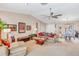 This cozy living room has a ceiling fan, a sofa, and a dining area at 230 Lotus Dr, Safety Harbor, FL 34695