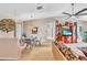 Open living room with dining table, media center, and comfortable seating area at 230 Lotus Dr, Safety Harbor, FL 34695