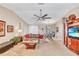 A spacious living room has a ceiling fan and adjacent dining area at 230 Lotus Dr, Safety Harbor, FL 34695