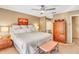 Primary bedroom featuring king bed, ceiling fan, and a bright, cozy atmosphere at 230 Lotus Dr, Safety Harbor, FL 34695