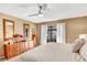 Bright Primary bedroom with king bed, access to patio, and dark wood furniture at 230 Lotus Dr, Safety Harbor, FL 34695