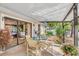 Covered patio with outdoor dining area featuring a table, chairs, and sliding glass doors at 230 Lotus Dr, Safety Harbor, FL 34695