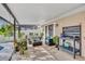 Covered outdoor patio featuring seating areas, potted plants, and a potting table at 230 Lotus Dr, Safety Harbor, FL 34695
