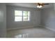 Living room features tile flooring, a ceiling fan, and a window overlooking the front yard at 2304 W Sligh Ave, Tampa, FL 33604