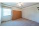 Bedroom with closet, murphy bed, neutral carpet and window with shades at 2610 Forest Run Ct, Clearwater, FL 33761