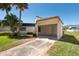 Home featuring a covered carport and well-maintained lawn and shrubbery at 2610 Forest Run Ct, Clearwater, FL 33761