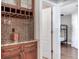 Wet bar includes wine storage, mosaic tile backsplash, and a view to a bedroom space at 2823 St Croix Dr, Clearwater, FL 33759