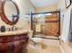 Bathroom showcasing vanity with granite countertop, decorative mirror, and tiled shower/tub combo at 2823 St Croix Dr, Clearwater, FL 33759