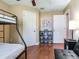 Bedroom featuring wood floors, natural light, a bunk bed and a comfortable couch at 2823 St Croix Dr, Clearwater, FL 33759