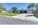 Charming single-story home with well-manicured lawn, large driveway, and a two-car garage at 2823 St Croix Dr, Clearwater, FL 33759