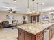 Kitchen with granite island and stainless dishwasher overlooks living room with leather furniture and artwork at 2823 St Croix Dr, Clearwater, FL 33759
