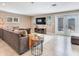 Comfortable living room with large sofa, television, and access to the outdoor patio at 2823 St Croix Dr, Clearwater, FL 33759
