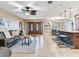 Open-concept living room featuring tile floors, dining area, and kitchen with bar stool seating at 2823 St Croix Dr, Clearwater, FL 33759
