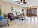 Bright living room featuring a large ceiling fan, comfortable seating, and double-door entryway at 2823 St Croix Dr, Clearwater, FL 33759