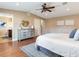 Inviting main bedroom with ensuite bathroom entrance, modern dresser, and ceiling fan at 2823 St Croix Dr, Clearwater, FL 33759