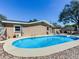 Backyard swimming pool with patio furniture and a building with neutral-colored walls at 2823 St Croix Dr, Clearwater, FL 33759