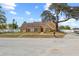 Inviting single story home with an orange facade, well-manicured lawn, and mature shade trees at 2912 Spaniel Ln, Seffner, FL 33584