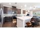 Modern kitchen featuring stainless steel appliances, dark wood cabinetry and a large quartz island at 2914 Grand Kemerton Pl, Tampa, FL 33618