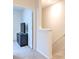 Upstairs hallway leading to a bedroom with neutral carpet and black furniture set at 2925 Beluga Bay Dr, Odessa, FL 33556