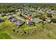 Aerial view of a home in a residential neighborhood with well-maintained lawns and mature trees at 3020 Silva Wood Dr, Valrico, FL 33596